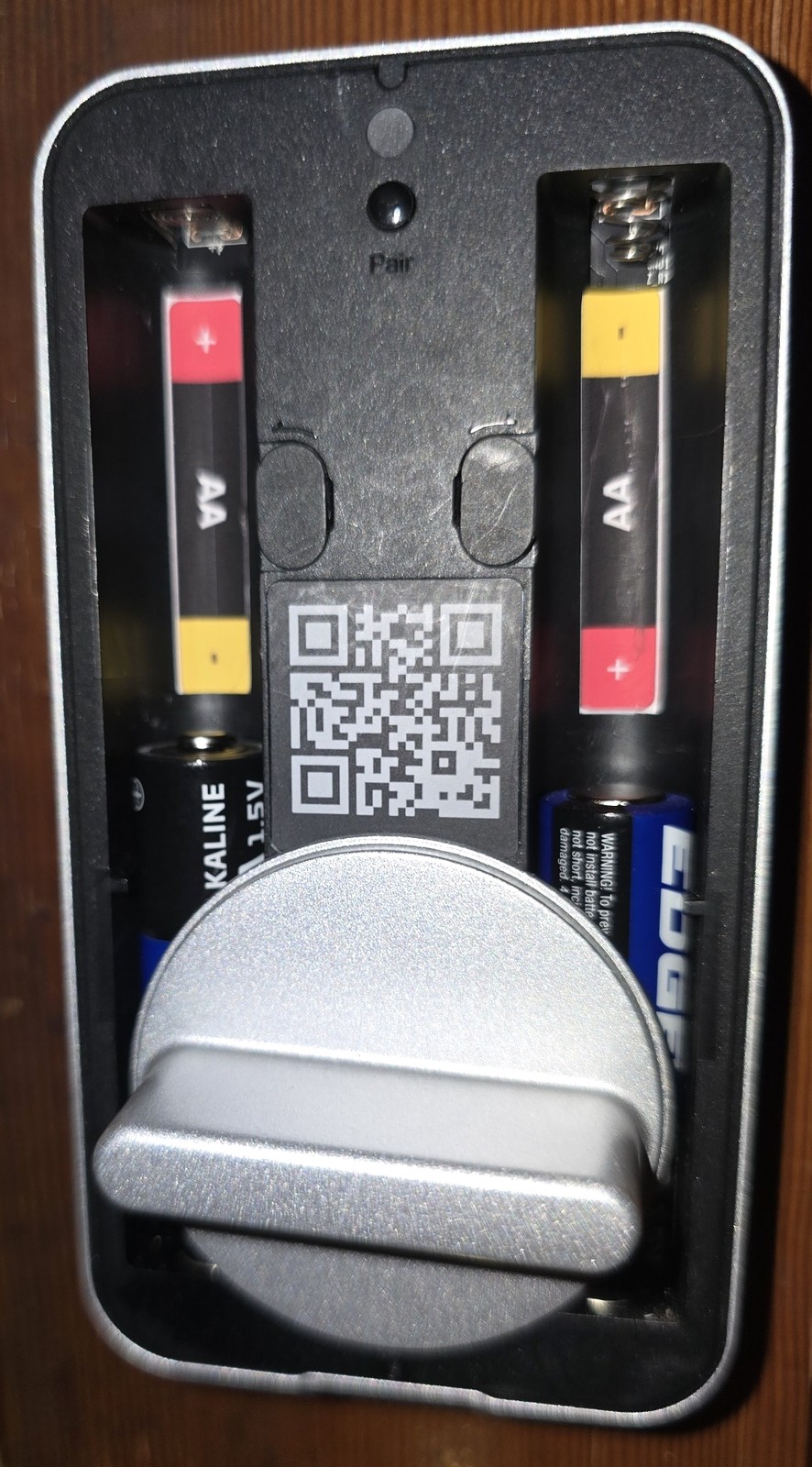 Battery compartment with two AA batteries that face opposite directions, labeled with BatteryBright