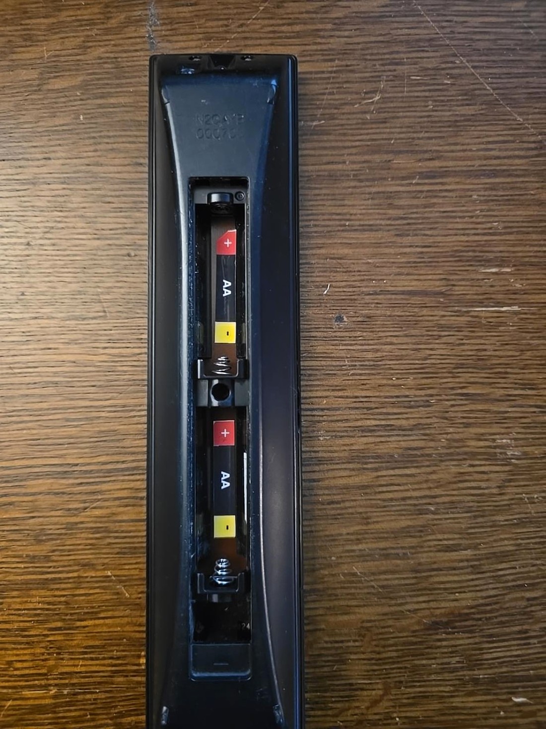 The same remote battery compartment after BatteryBright AA direction labels are installed